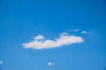 Fluffy cumulus clouds against bright blue sky