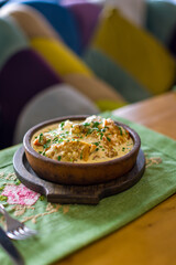 chicken chkmeruli in Georgian with creamy sauce on old wooden table