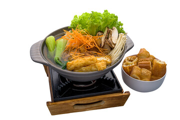 Black Kut Teh Lion Mane Hot Pot served in a stew dish isolated on plain white background side view...