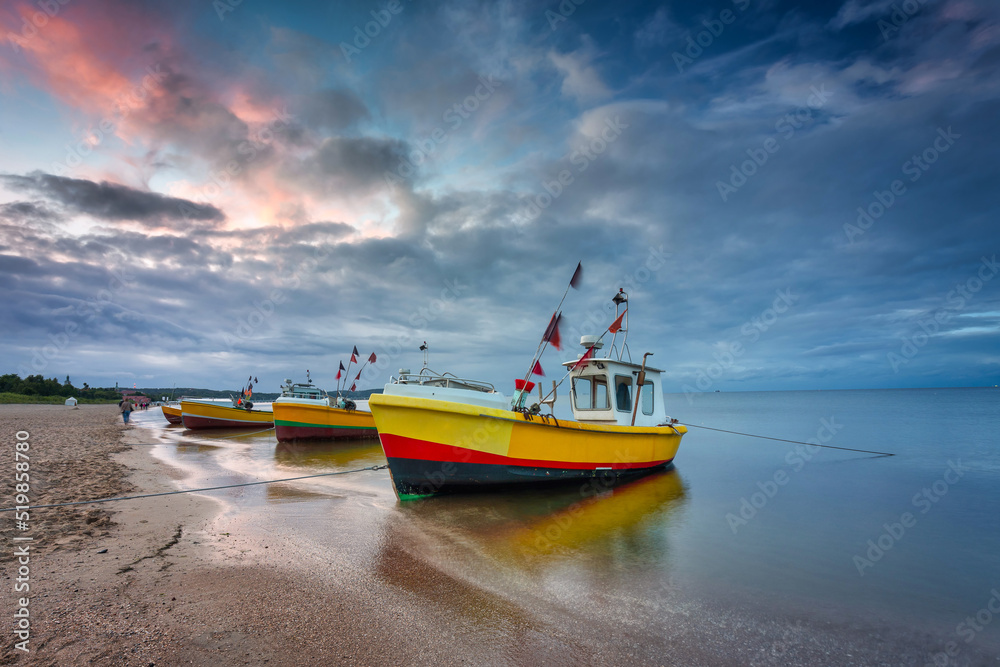 Wall mural beautiful sunset with fishing boats at the beach of baltic sea in sopot, poland