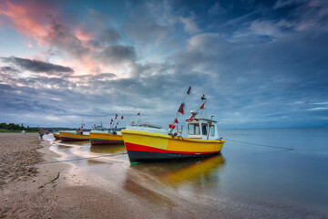 Beautiful sunset with fishing boats at the beach of Baltic Sea in Sopot, Poland - obrazy, fototapety, plakaty
