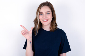 young caucasian woman wearing black T-shirt over white background pointing up with fingers number eight in Chinese sign language BÄ.