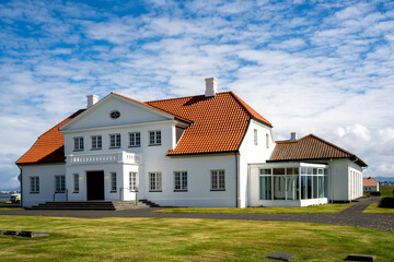 Álftanes, Iceland - July 1, 2022 View of the main building of the Bessastadir, a modest group of white, red-roofed buildings that is the official residence of the president of Iceland.