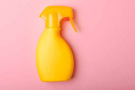 Sunscreen on a pink background. Plastic bottle of SPF sunscreen. Sunscreen selection.Summer travel beach flat lay composition, banner. Summer vacations and spf uv-protecting skin care concept.