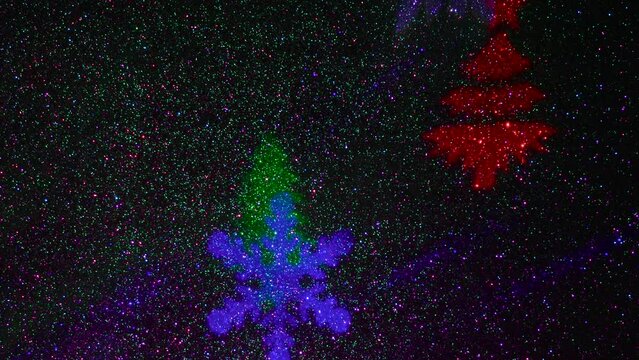 A carousel of light beams of different colors is set against a constantly flashing background that changes colors. Flying colored silhouettes of Christmas trees and snowflakes.