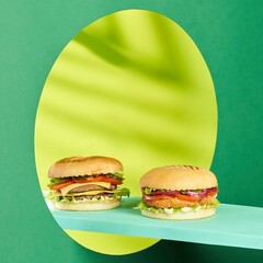 Burger with juicy marbled beef patty, freshly baked bun, fresh farm vegetables, melting cheese and signature sauce. Burger on the background of the mirror. Side view. 