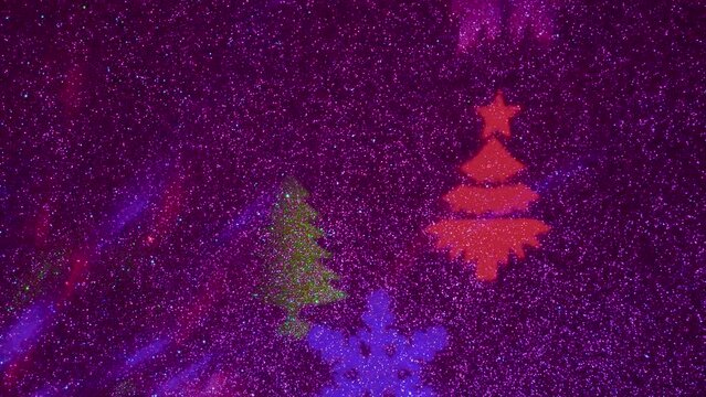 A carousel of light beams of different colors is set against a constantly flashing background that changes colors. Flying colored silhouettes of Christmas trees and snowflakes.
