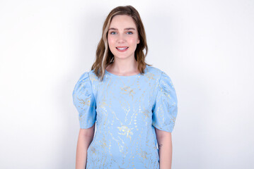 Obraz premium young caucasian woman wearing blue T-shirt over white background with nice beaming smile pleased expression. Positive emotions concept