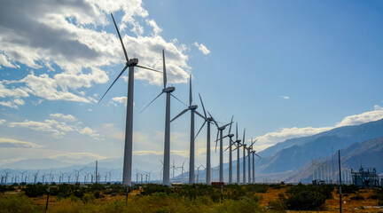 View of wind turbines generating electricity. Huge array of gigantic wind turbines spreading over the desert in Palm Springs wind farm, California