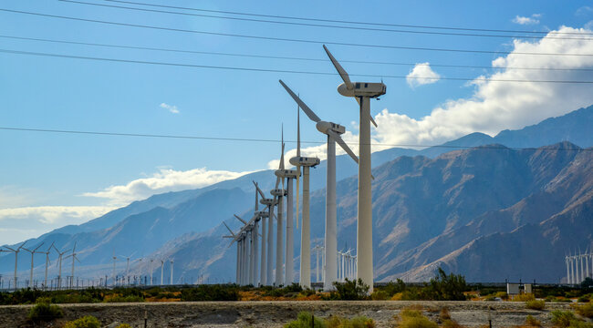 View of wind turbines generating electricity. Huge array of gigantic wind turbines spreading over the desert in Palm Springs wind farm, California