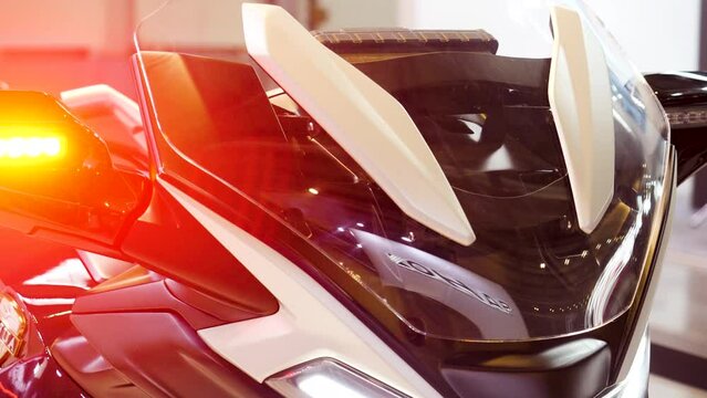 Close up of police motorcycle with blinking blue and red signal lights. Media. Details of the police motorbike.