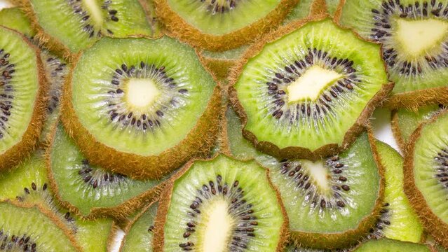 Kiwi slices becomes dry and wrinkled. Fruit dehydrates quickly. Fast timelapse. Concept of aging, time, health, skincare, cosmetic care.