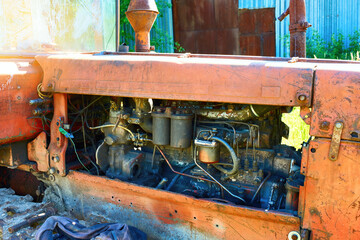 View of the engine of an old tractor in the sunlight. Diesel engine.