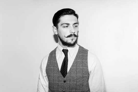 Black and white image. Male beard and mustache. Elegant handsome man in suit. Handsome bearded businessman in classic suits.
