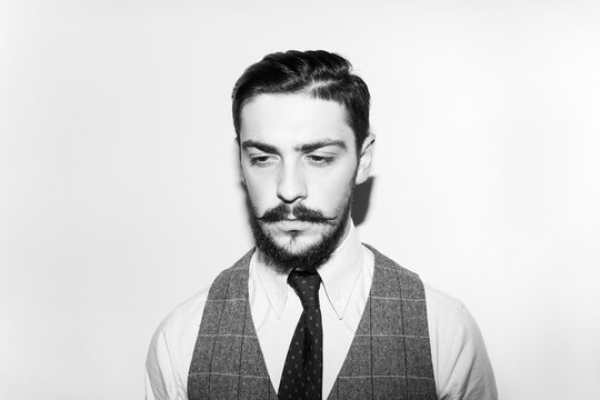 Male beard and mustache. Elegant handsome man in suit. Handsome bearded businessman in classic suits. Black and white image.