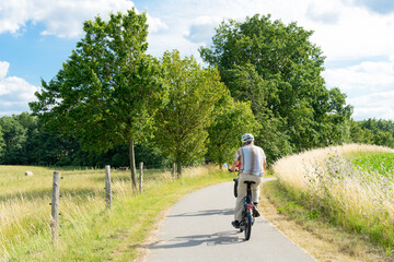 Fototapeta premium Outdoor activities in Mecklenburg Western Pomerania, actively organize holidays. Cycling trough the beautiful landscape in summer time on quiet country roads with wonderful views 