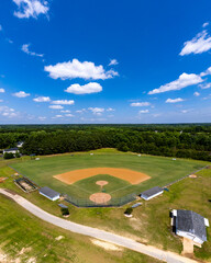 Fototapeta na wymiar aerial drone photograph of a baseball field and blue sky with clouds