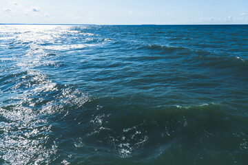 Deep blue sea on a sunny day, blue water surface with waves