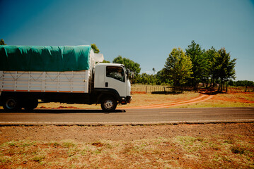 A truck is passing along a road in a simple African country. Kenya, country road outside the town of Eldoret