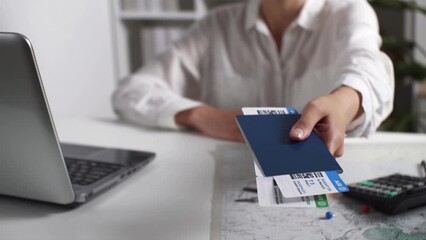 Buying air tickets. Woman holds out tickets, passports, buys plane tickets, working on laptop. Travel, transport concept, buying booking. Flight booking, travel, traveler get tickets, vacation booking - Powered by Adobe