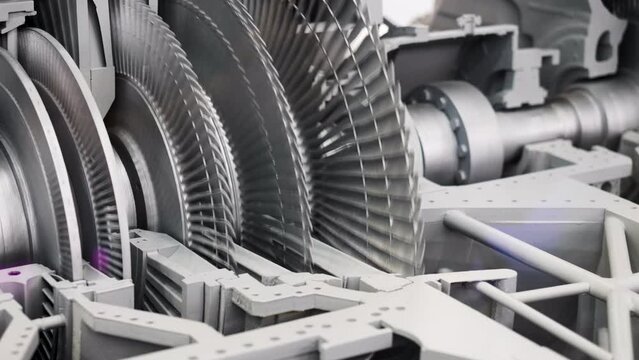 Rotating round parts in production machine. Media. Steam turbine generator at factory. Modern metal machines and generators. Gas or steam turbine generator