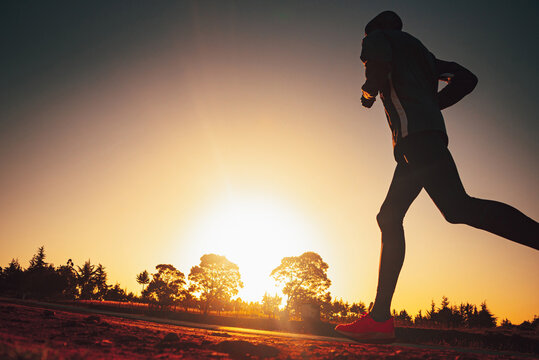 Silhouette of a Kenyan runner at sunrise. Photo from marathon training with edit space