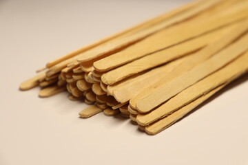 Wooden disposable sticks for stirring drinks. Ecological tableware.