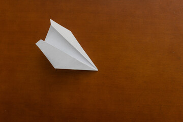 paper airplane on an old wooden table