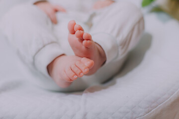 The baby 's legs are in flowers .