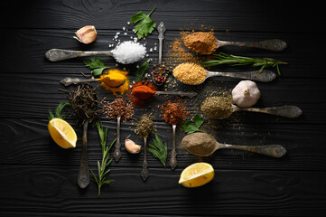 Obraz na płótnie Canvas Colorful various herbs and spices for cooking on dark wooden rustic background