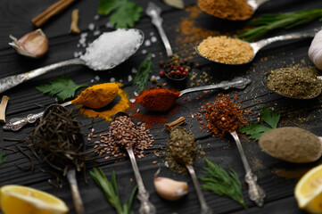 Obraz na płótnie Canvas Colorful various herbs and spices for cooking on dark wooden rustic background