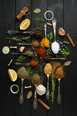 Fototapeta na wymiar Colorful various herbs and spices for cooking on dark wooden rustic background