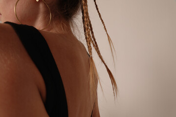 Close-up picture of back view of young woman sitting in the studio. Mock-up.