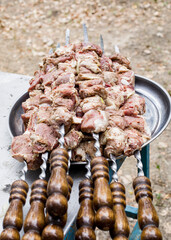 Raw barbecue. Steak meat on a metal skewers. Meat background. Raw barbecue meat on skewers. Meat close-up.