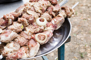 Raw barbecue. Steak meat on a metal skewers. Meat background. Raw barbecue meat on skewers. Meat close-up.