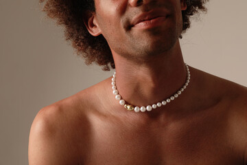 Portrait of a bare chested African American man with pearl necklace. Mock-up.
