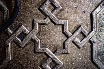 Iron door sculpture script detail on ancient Arabian gate close up still