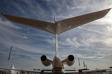 Tail and Engines wide angle view of a private jet parked on the ground of a airport  