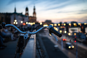 Handlebars of a bike standing in Dresden (Germany) city centre at dusk.