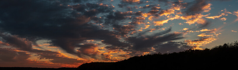 fire sunset over forest hills