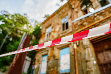 fence tape at the old ruined building. house out-of-focus