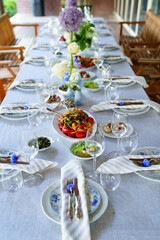 beautiful setting of a large table with snacks and flowers. 
