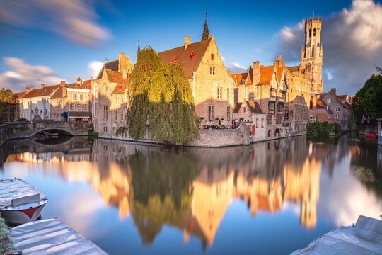 Rozenhoedkaai canal reflection at sunrise and blurred clouds, Bruges