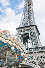 Eiffel Tower and carousel during a sunny day in Paris, France