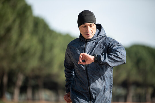 Man running in park at winter morning