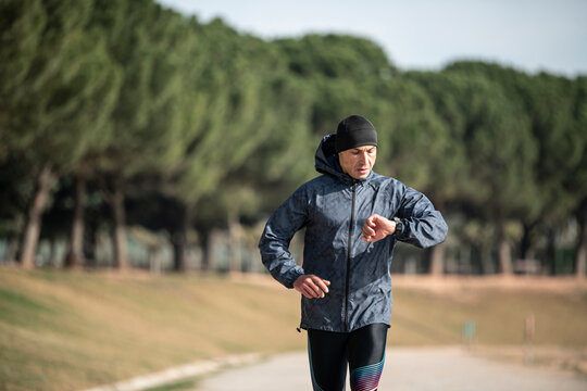 Man running in park at winter morning