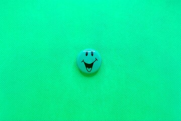 Happy smiley magnet with open mouth isolated on a green background with copy space for your message.