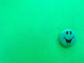 Happy smiley magnet with open mouth isolated on a green background with copy space for your message.