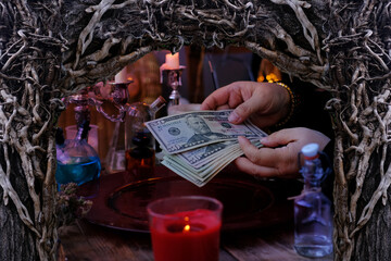 seance in salon of soothsayer, female hands of psychic doing witchcraft passes with money, esoteric Oracle performs ritual of removing spell of black magic, esoteric business, magic to increase income - obrazy, fototapety, plakaty