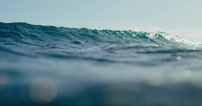 Blue ocean wave breaking in slow motion